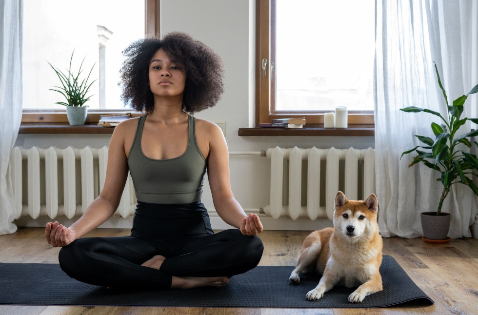 Woman doing yoga with her dog